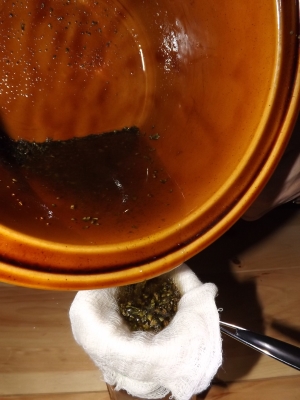 Strain the cannabis infused coconut oil through cheesecloth