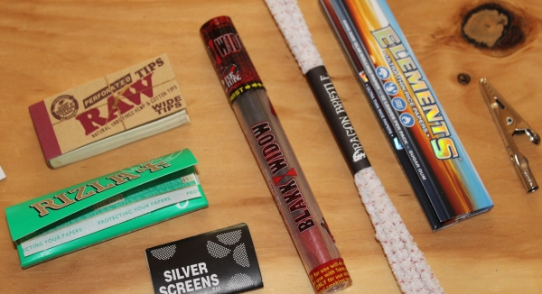 Rolling papers and items from Dollar High Club Primo Box
