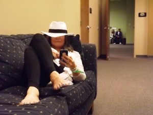 Woman in hat on couch at Denver Cannabis Cup