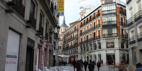 Street with Church tower sticking out in Madrid Spain