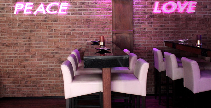 High tables with and pink neon lights